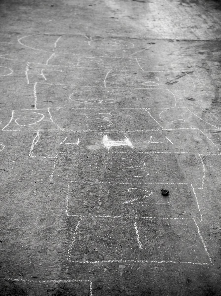 Chalk hopscotch grid on pavement